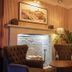 Dog and Partridge by Greene King Inns in Bury St. Edmunds lounge with fireplace, armchairs and plants