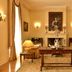 Pousada Palácio de Queluz salon with fireplace, chandelier, antique table and cream seating in Queluz