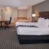 La Quinta Inn & Suites by Wyndham Indianapolis South guest room with king bed, desk, TV, and soaking tub