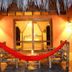 La Casa de Sebas in Máncora: red hammock on a bamboo porch with warm lantern lighting