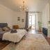 Les Suites de Bellac guest room with king bed, chandelier, fireplace, and seating area in Bellac