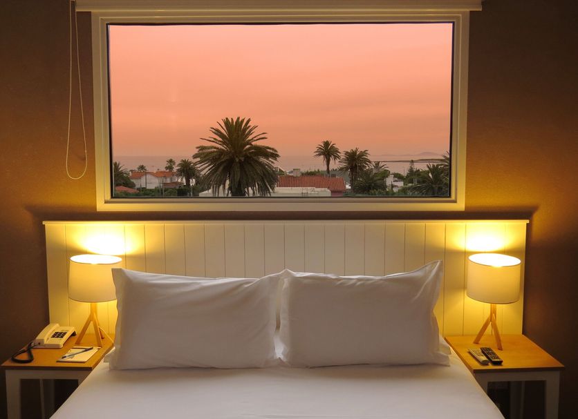 Atlántico Boutique Hotel in Punta del Este room with sunset ocean view through window