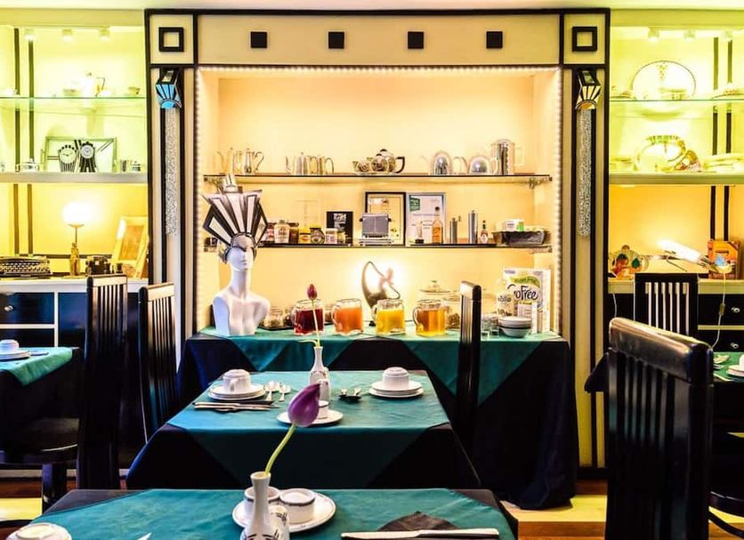 Paskins Town House Brighton dining room with set tables and illuminated shelves