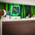 Quality Inn & Suites By the Parks front desk with staff in Kissimmee lobby