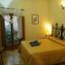 Residence Palazzo Baldi in Galatina: double bed with wrought-iron headboard and balcony doors in guest room