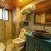 Secret Courtyard Resort Hotel Guilin bathroom with glass shower, toilet and blue vanity