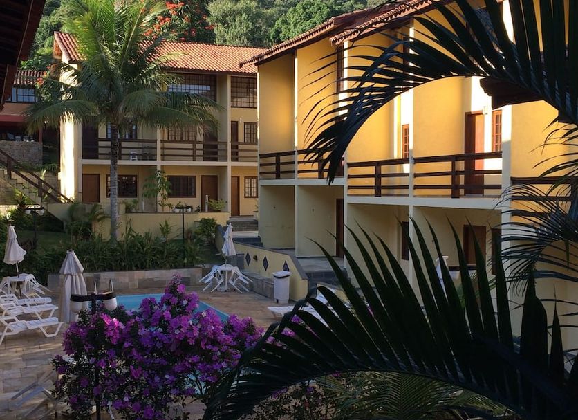 Hotel da Ilha in Ilhabela courtyard with pool, lounge chairs, balconies and tropical greenery