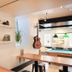 Auberge Saintlo Montréal Hostel in Montreal lounge with shelves of plants, guitar, and pool table