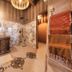 Ksar Ighnda in Aït Ben Haddou: rustic spa bathroom with mosaic shower floor and hanging lanterns