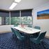 Meeting room at The York by Swiss-Belhotel in Sydney with blue chairs, table, large windows and city views