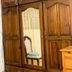 Duen Hotel in Delmas with a large wooden wardrobe and mirror in a guest room