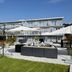 Aparthotel Baden in Baden with outdoor patio seating and umbrellas by the hotel building