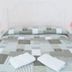 Sfumature Partenopee Naples room with double bed, patterned bedding, pink bedside lamps, and folded towels
