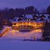 Lake Placid Lodge in Lake Placid, illuminated lakeside lodge with snow-covered grounds at dusk