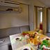 hu I Pini village in Fiano Romano: compact cabin dining area with table set and open door to a small deck