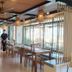 The Beach Resort & Residence - Sha Plus in Pathio: airy dining room with wooden tables and large windows