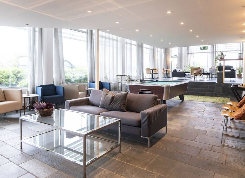 Aiden by Best Western Haugesund Airport lobby in Avaldsnes with seating, large windows and a pool table