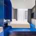 Yiting Huicheng Hotel Xiamen guest room with bright blue platform bed and floor-to-ceiling window