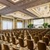 Four Seasons Hotel Shenzhen conference room with rows of brown chairs and a large presentation screen