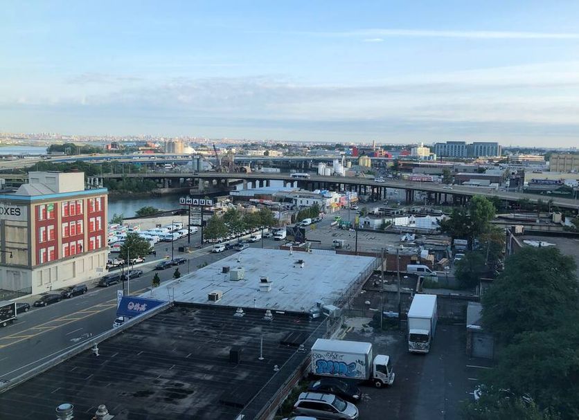 John Hotel in Queens with city view over highway, waterway and rooftops