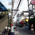 Northlands House Hotel in Chiang Mai on a narrow street with hanging plants and overhead power lines