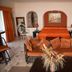 Villablanca Garden Beach Hotel in Cozumel room with orange bed, sofa, and wicker chairs