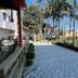 Hotel Arco Do Sol in Balneário Camboriú with a palm-lined tiled courtyard walkway