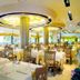 Hotel Europa Bibione dining room with set tables, large windows, and bright ceiling lights