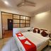 Park Palace Hotel Kolkata guest room with double bed, ceiling fan and partitioned sitting area
