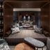 The Lively Fukuoka Hakata lounge with built-in seating, patterned cushions, and wine bottle shelving in Fukuoka.