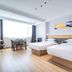International Haiyuan Resort Hotel in Nantong: bright twin-bed guest room with large window and dining table