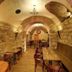 Martin Hotel Prague in Prague, stone-arched cellar restaurant with wooden tables and chairs