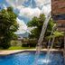 Courtyard by Marriott San Salvador pool with waterfall feature and mountain view in San Salvador