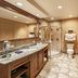 Sky Ute Casino Resort in Ignacio bathroom with granite vanity, walk-in shower, and toilet