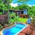 Pousada Villa Da Prainha in Ilhabela with a small pool, tropical garden, and wooden deck chairs