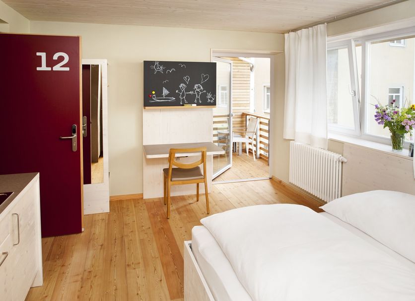 Familienhotel Weimar room with two single beds, desk, chalkboard wall art and bright window seat in Weimar