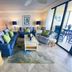 Resort Harbour Properties Fort Myers living room with blue sofas and balcony view