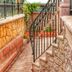 Stone Hill Boutique in Ayvalik: stone staircase and wrought-iron railing in a narrow outdoor passage