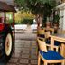 Hotel Gremersdorf - Zum Grünen Jäger courtyard with red tractor display and outdoor seating in Gremersdorf