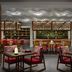 Anantara Veli Maldives Resort restaurant with patterned chairs, tables, and decorative shelving in Veligandu Huraa