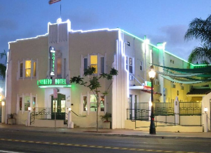 El Primero Hotel in Chula Vista, exterior at dusk with lit facade and neon sign