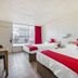 OYO Hotel Waco University Area/ I-35 room with two beds and red accents in Waco