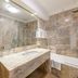 Pousada Viana do Castelo bathroom with marble vanity, mirror, and bathtub-shower in Viana do Castelo