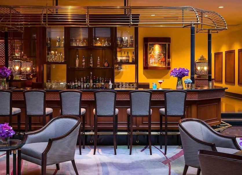 The Heritage Grand Khon Kaen Hotel and Convention bar with stools and purple floral accents in Khon Kaen