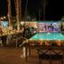 A Place In The Sun - Adults Only in Palm Springs, lit poolside dining with palm trees at night
