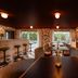 Royal Sun Palm Springs lounge with floral wallpaper, patterned seating, bar stools and large windows