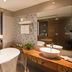 Van Phat Riverside Hotel in Can Tho suite with bathtub, king bed, and large bathroom vanity