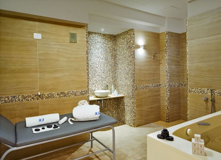 Hotel Floridiana Terme Ischia spa treatment room with massage table and tiled hydrotherapy tub