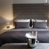 The Lane Hotel Edinburgh bedroom with king bed, bedside lamps, and upholstered headboard