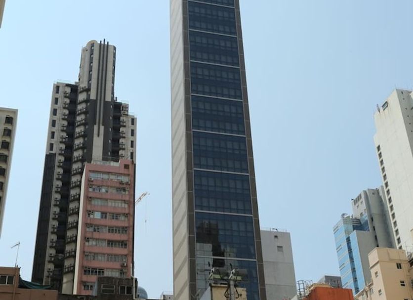 We Hotel in Hong Kong skyline view with tall modern tower and surrounding city buildings
